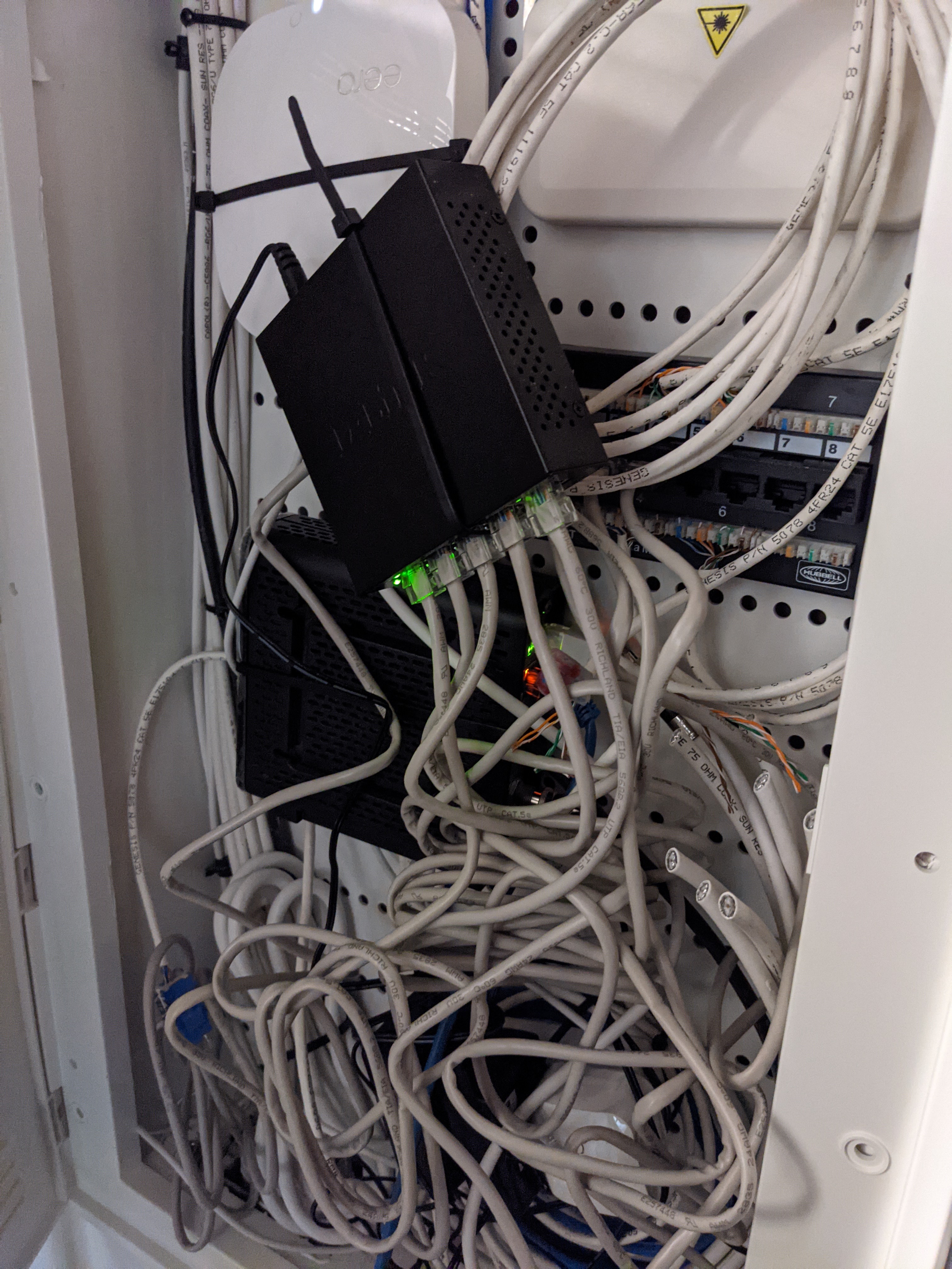 Messy cabinet of cables strung about.