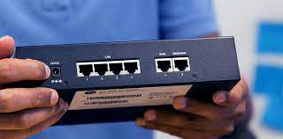 Araknis router held in a technicians hand