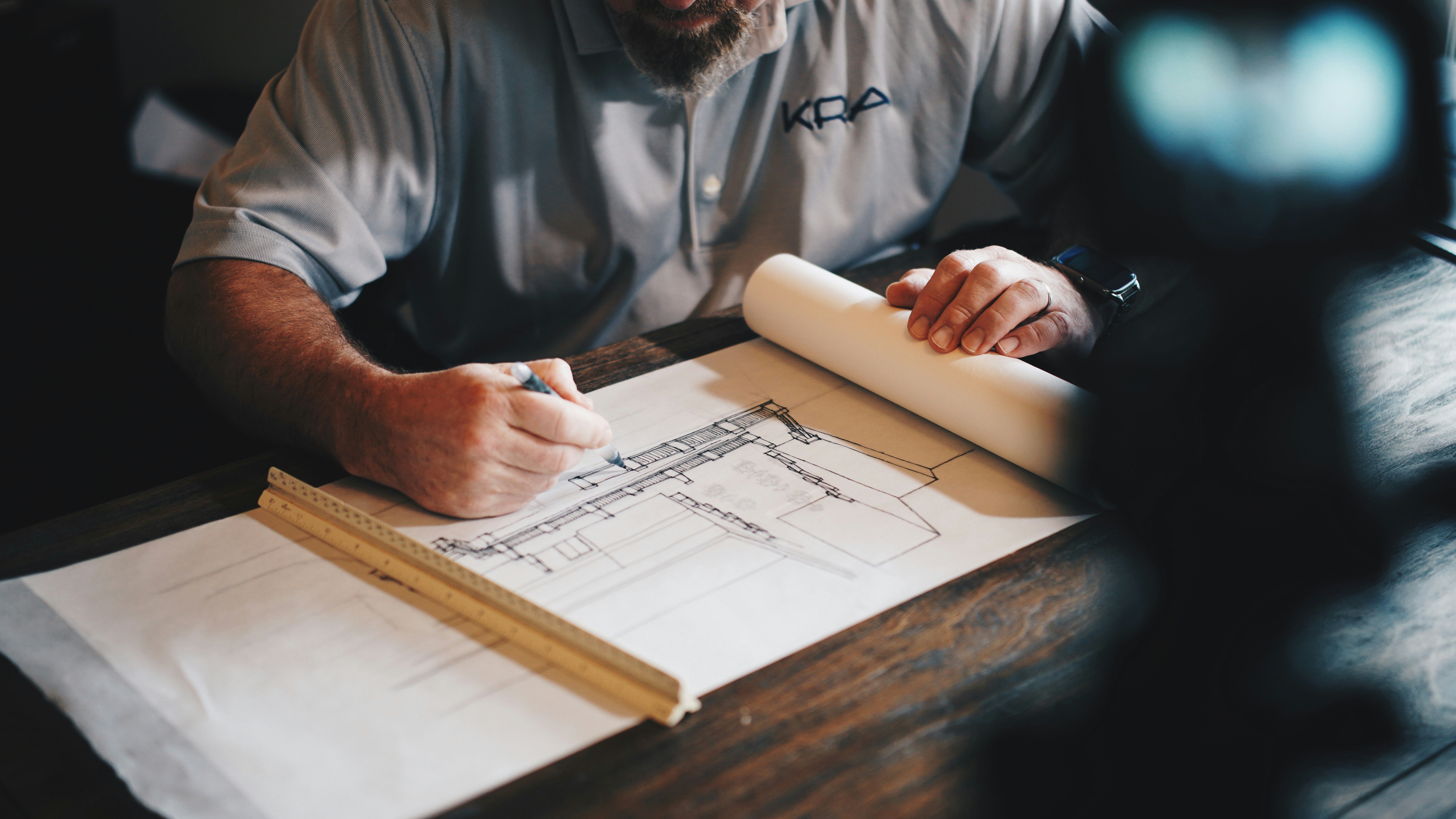 Man drawing structured cabling blueprints.